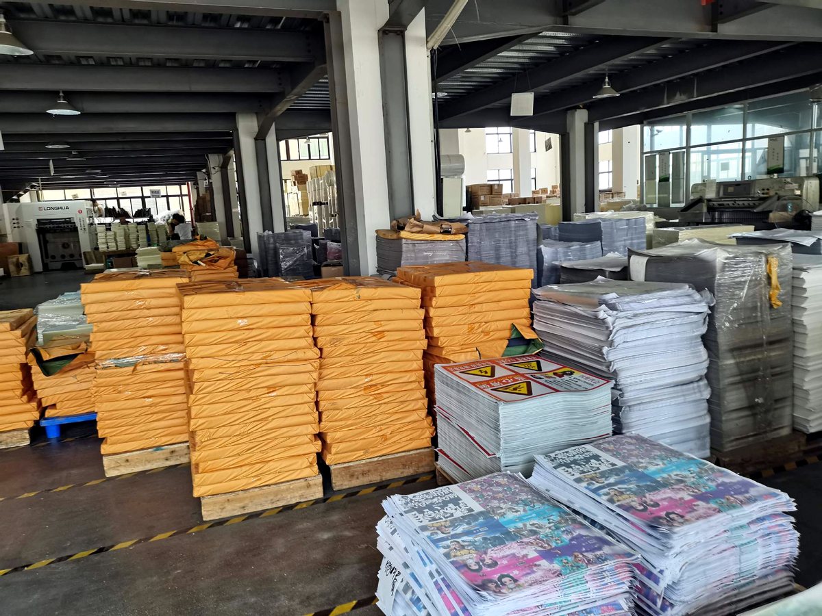 Inside our printing workshop with stacks of printed sheets