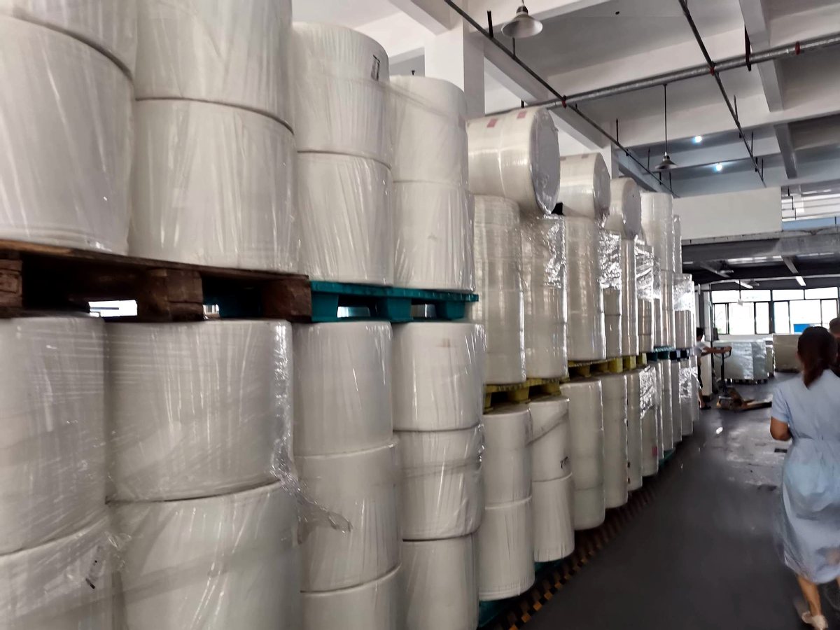 Raw material warehouse with non-woven fabric and paper rolls
