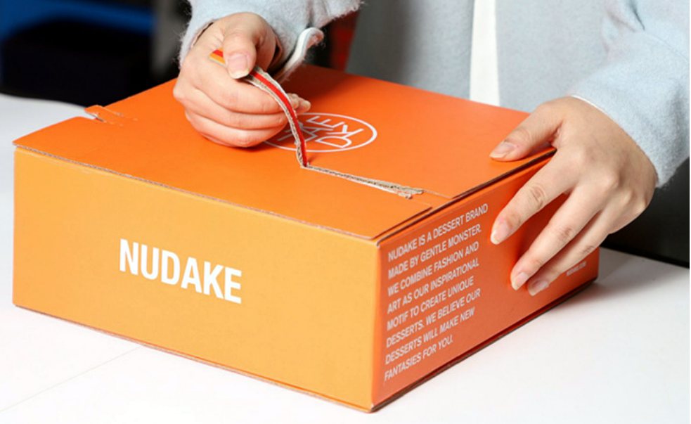 Custom tear-strip mailer box being opened