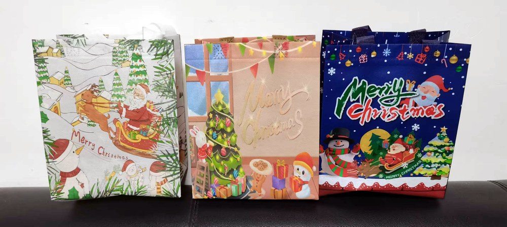 Custom laminated Christmas gift bags with full-color printing — Santa Claus and festive designs, made by Lion Pack